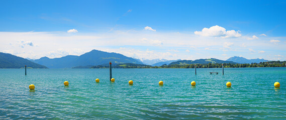 Swimming area on Lake Zug with yellow buoys and a view of Mount Rigi. Central Switzerland. © SusaZoom