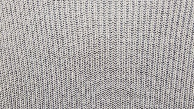 macro tracking shot reveals cozy grey wool knit texture swirling into an authentic warm winter fashion concept