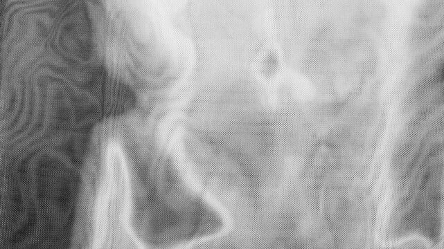 monochrome metallic mesh fabric ripples under dynamic studio light creating abstract waves of silver moire texture