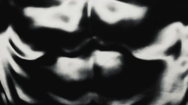 grainy textured liquid morphs slowly in a surreal monochromatic abstract visual loop