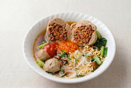 Spicy bakso meatball noodle soup with sambal and vegetables