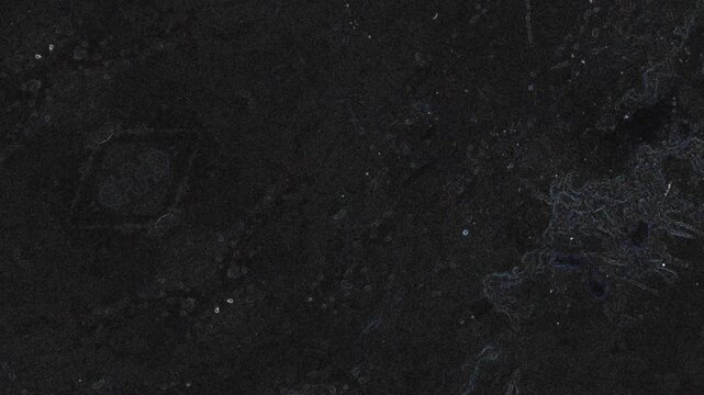 Dark weathered surface with subtle textures, scattered specks, and faint organic scratch patterns. Grunge texture background animation.