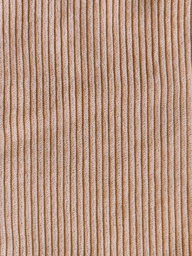Beige wide wale corduroy fabric texture seamless background