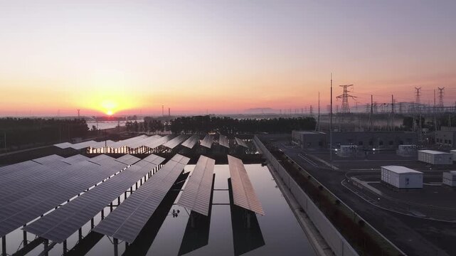 Sunset view of energy storage equipment array at a substation facility