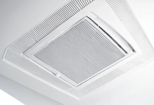 Modern ceiling air conditioning unit with white filter grid showcasing HVAC ventilation system, indoor climate control, clean design, and energy efficient residential and commercial installation.
