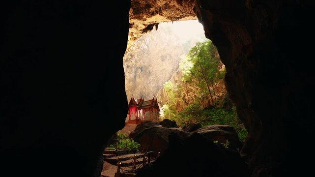 Tourist traveler in Phraya Nakhon Cave with sunlight, Adventure trip in Thailand, Landmark Royal pavilion.