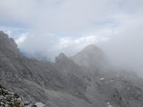 Panoramic view of Logarska dolina valley with peaks of Slovenian Alps covered by passing clouds.