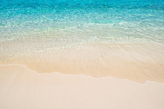 Blue calm sea water in sunny day with transparent waves and clean tropical sand beach