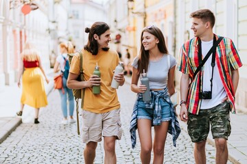 Fototapeta premium Young tourists sightseeing on charming European street