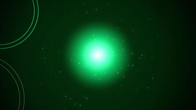Abstract green energy light burst with particle effects on dark background