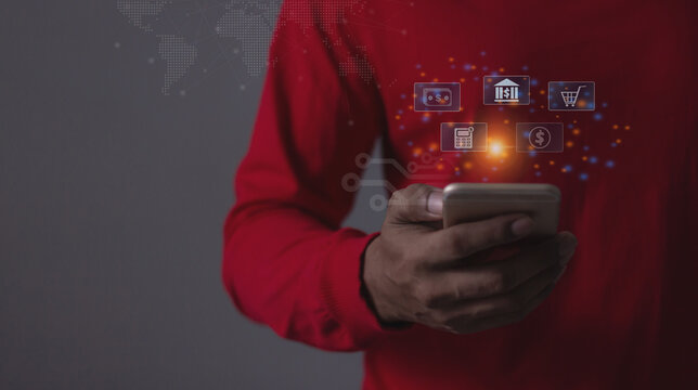 Young man with smartphone hand touching to visualize money growth The phone screen displays graphs and charts showing increasing investment and savings trends, along with an increased account balance