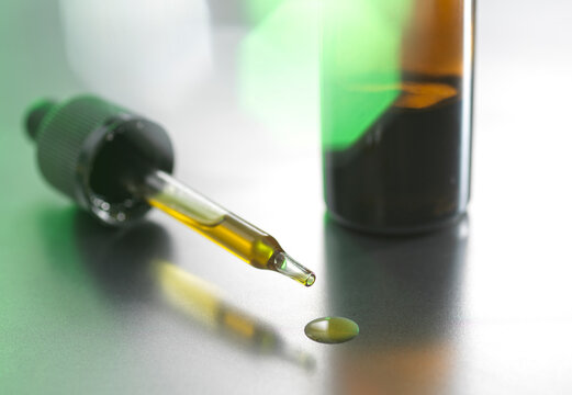 Dropper with CBD oil on table