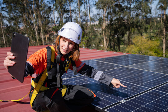 Technician inspecting rooftop solar panels on a video call
