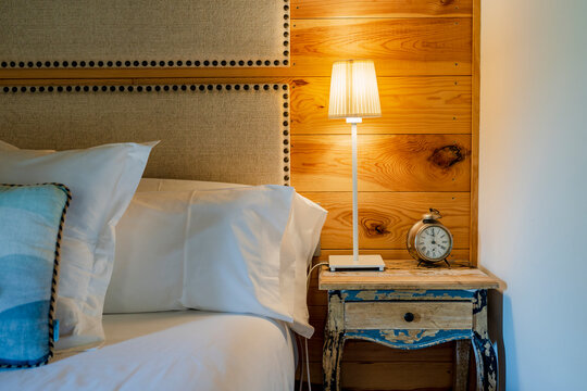 Illuminated lamp on night table in hotel