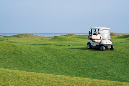 Turkey, Antalya, Golf cart on meadow at golf course