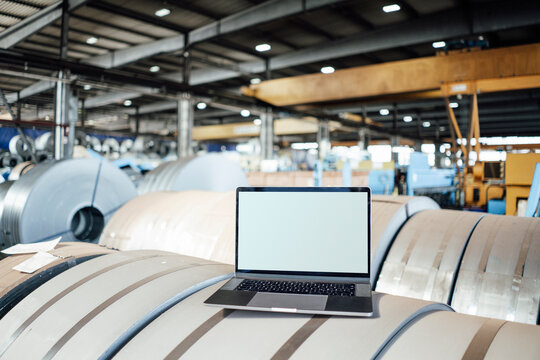 Laptop on manufactured metal sheet in industry