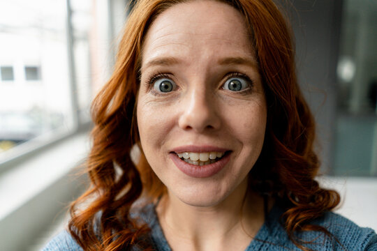 Portrait of starring redheaded woman