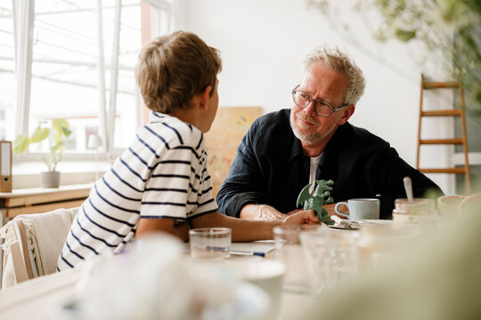 Father and son having a serious talk at home