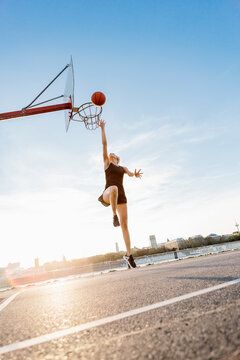 Blonde woman playing basketball in Cologne, Germany