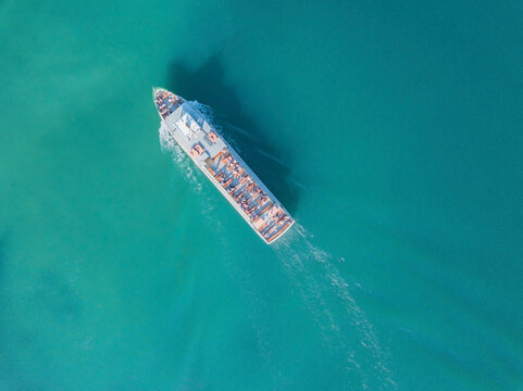 Germany, Bavaria, Aerial view of tourboat sailing across turquoise waters of Chiemsee lake