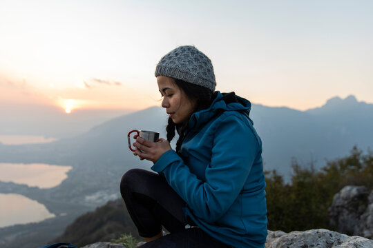 Woman having coffee on mountain