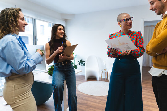 Business colleagues discussing document in modern office