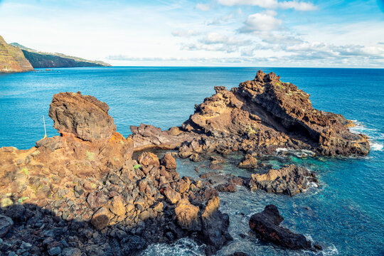 Volcanic rock and blue ocean at Playa de Nogales in La Palma Spain