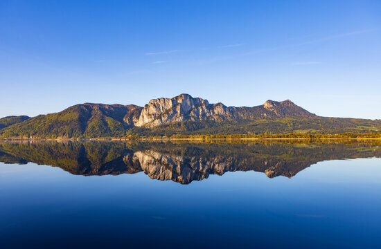 Majestic mountain reflecting perfectly in a calm blue lake