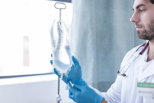 Nurse adjusting intravenous drip