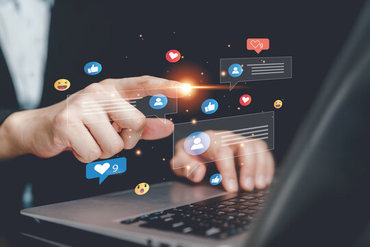 Businessman using laptop with social media interaction icons, online communication, digital marketing engagement, customer feedback, networking, content strategy and social media management concept.