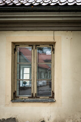Fototapeta premium Old Wooden Window on Weathered Historic Building Facade