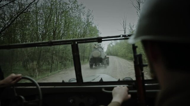 View from a car of a Soviet armored vehicle on a forest road
