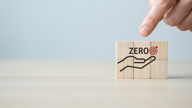 A hand places a wooden block with a zero symbol and a line drawing on a table indoors.