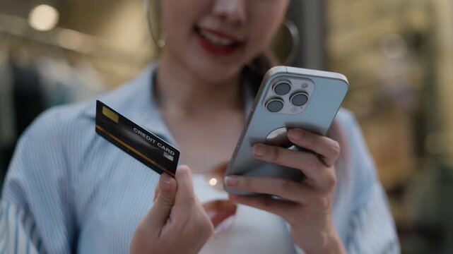 Asian woman entering credit card info and OTP security code on smartphone for online shopping, representing mobile payment transaction, cyber security financial protection data