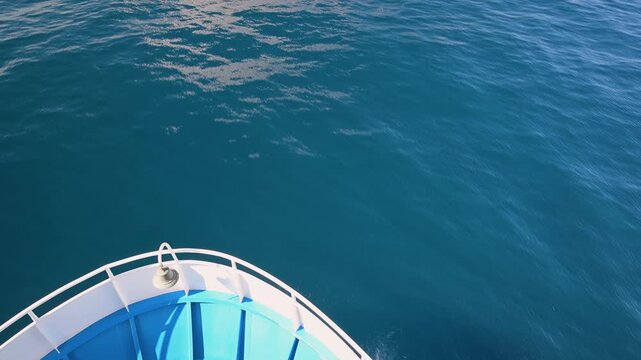 Boat bow sailing and splashing on blue sea water in Greece