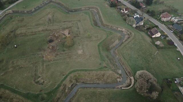 Drone footage over Jablunkov Fortress reveals ancient earthworks, settlement mounds, and archaeological features within the historic landscape.