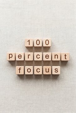 100 percent focus concept with wooden blocks motivation message