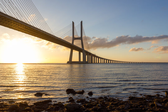 Sunset view of the Vasco da Gama Bridge crossing the Tagus River in Lisbon Portugal