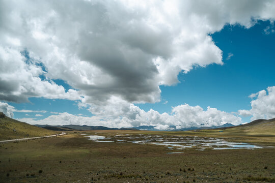 A serene lake amidst a mountainous landscape of the Peruvian Andes.