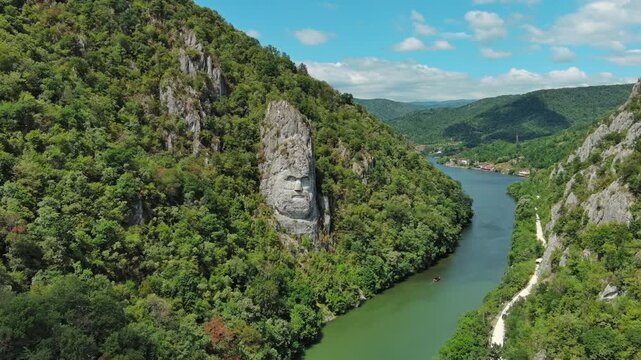 Aerial view of stone carved statue portrait of ancient dacian king Decebal. Sculpture located on shore of Danube River, Romania, 4k