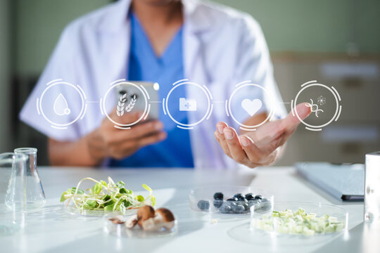 A researcher uses a smartphone to analyze food nutrition and biological data with a futuristic digital interface.