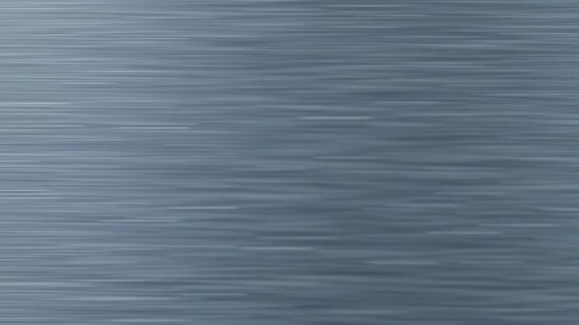 Extreme close-up macro video of a pristine brushed metallic surface with fine horizontal grain, soft reflections, and slow pans, deep focus. Concept of modern precision and advanced technology