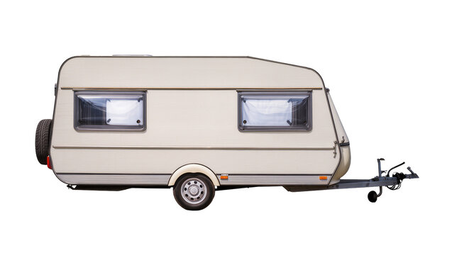 Cream colored travel trailer with spare tire and windows
