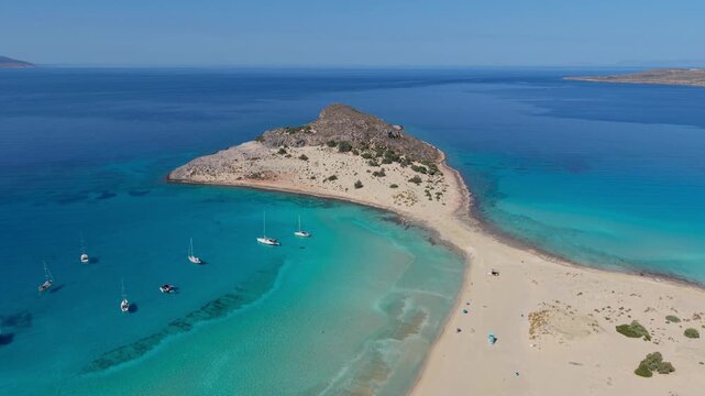 Discover the breathtaking beauty of Simos Beach in Elafonisos, Greece, where turquoise waters meet golden sands. Perfect for sunbathing and relaxing in a serene atmosphere.