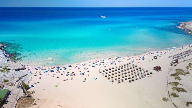 Scenic view of Cala Mesquida beach with turquoise water and sand dunes in Mallorca, Spain