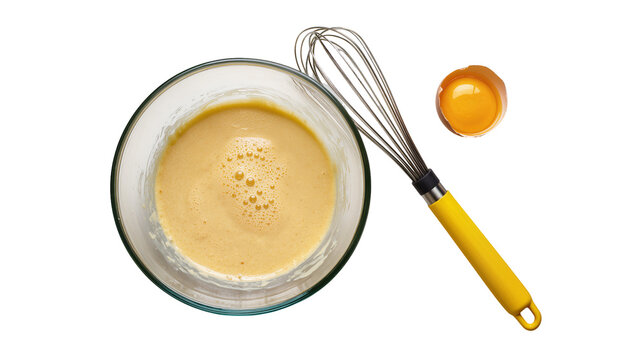 Whisked egg mixture in glass bowl with egg yolk and whisk