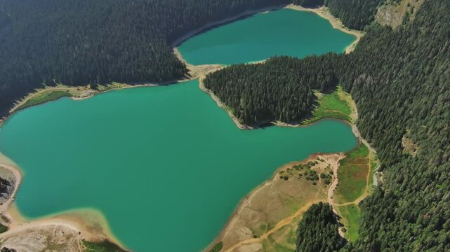 Aerial around view of Black Lake in mountain Durmitor park at summer, Montenegro, 4k