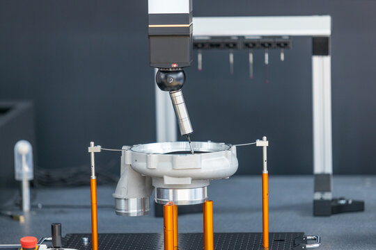 Motorized indexing probe head inspecting precision metal component on coordinate measuring machine in advanced quality control laboratory. Reverse engineering concept.