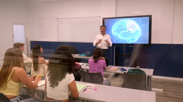 Male university professor teaching a neuroscience class, pointing to a 3d animated brain model on a large digital screen while students listen and take notes in a modern classroom