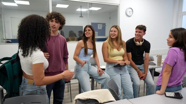 Diverse group of friendly teenage students happily greeting and welcoming a new female classmate with a handshake inside a modern high school classroom, fostering a positive learning environment
